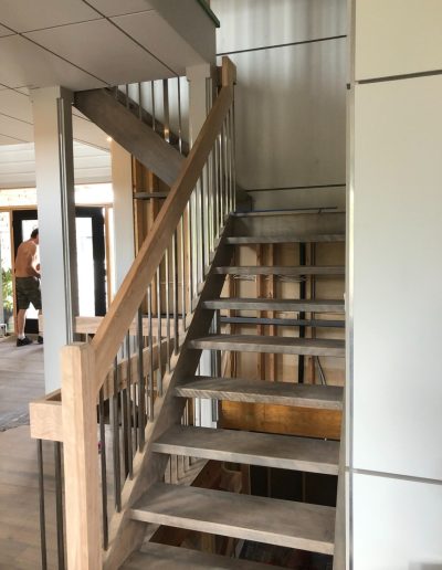 Modern open-riser wood staircase with custom railing in Simcoe County