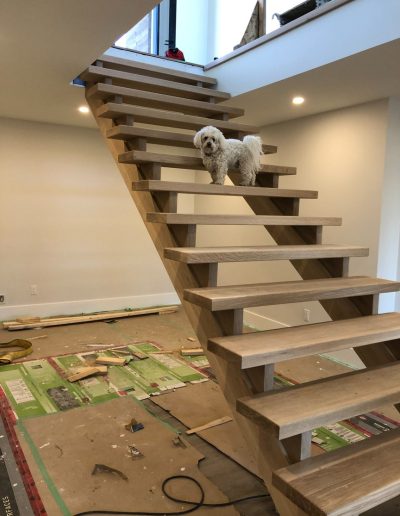 Custom open riser wood staircase with solid wood treads in a Simcoe County residence
